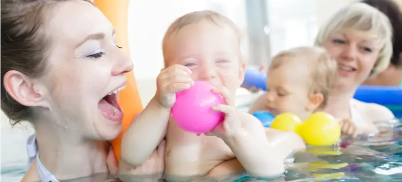 Mothers and babies having fun in the pool