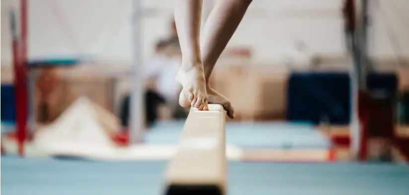 Gymnast balancing on the beam