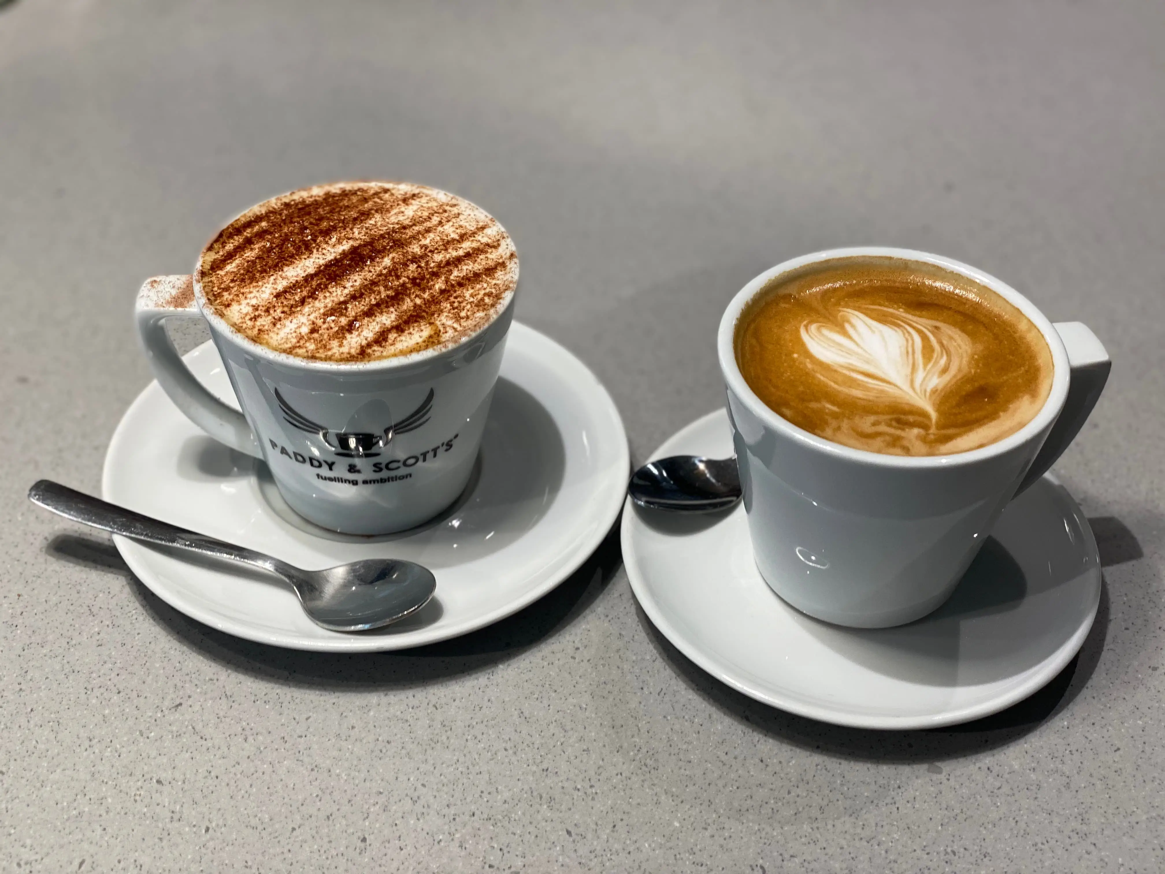 Two cups of frothy coffee