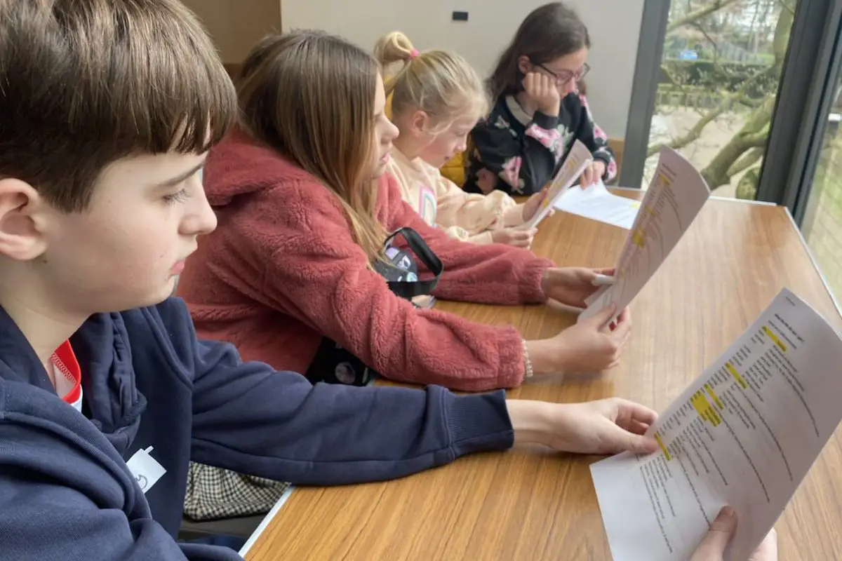 The kids at Radio Club look over their scripts. 