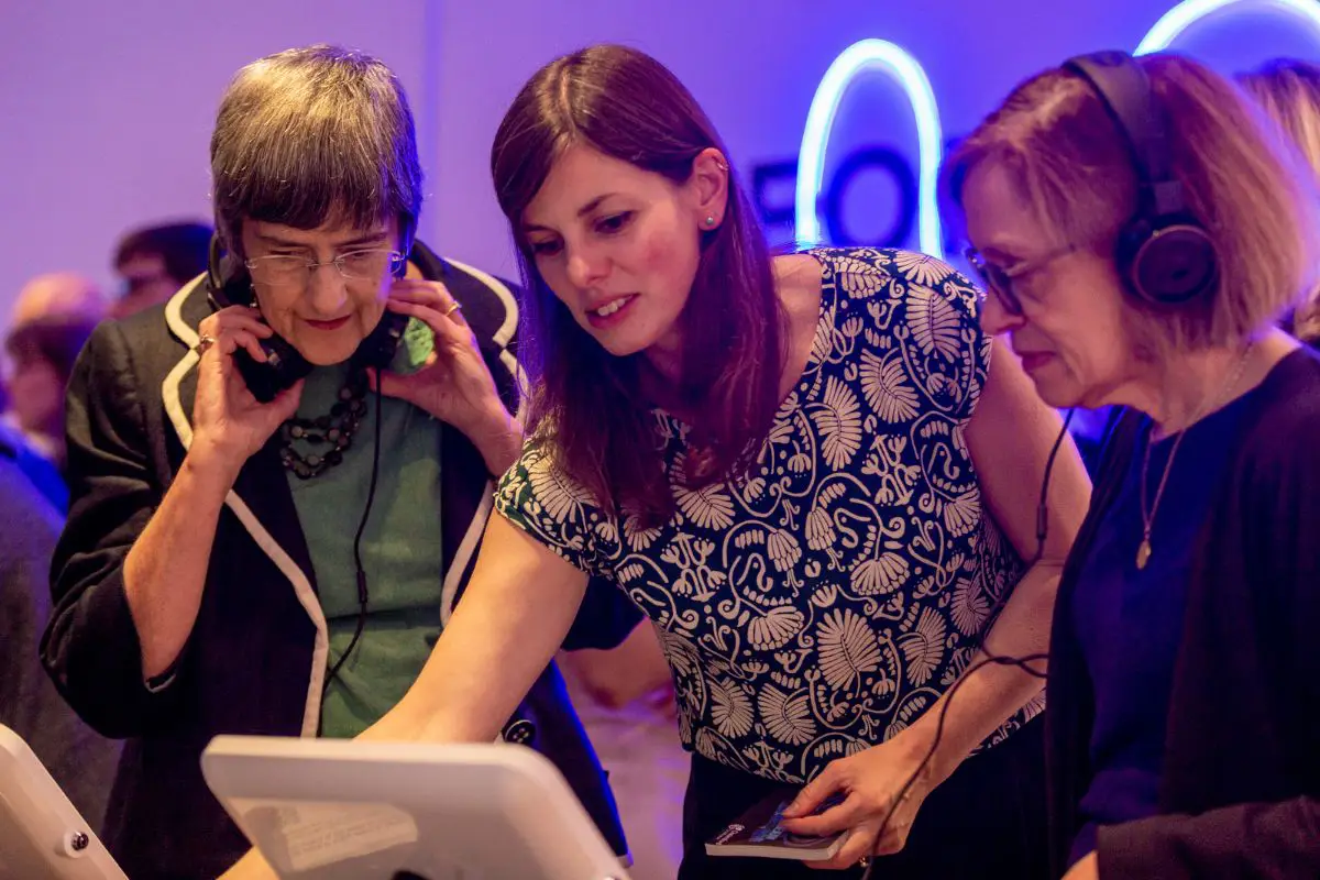 Curator Sarah Harvey demonstrates the digital exhibition on the tablet at the Forecast22 launch. 