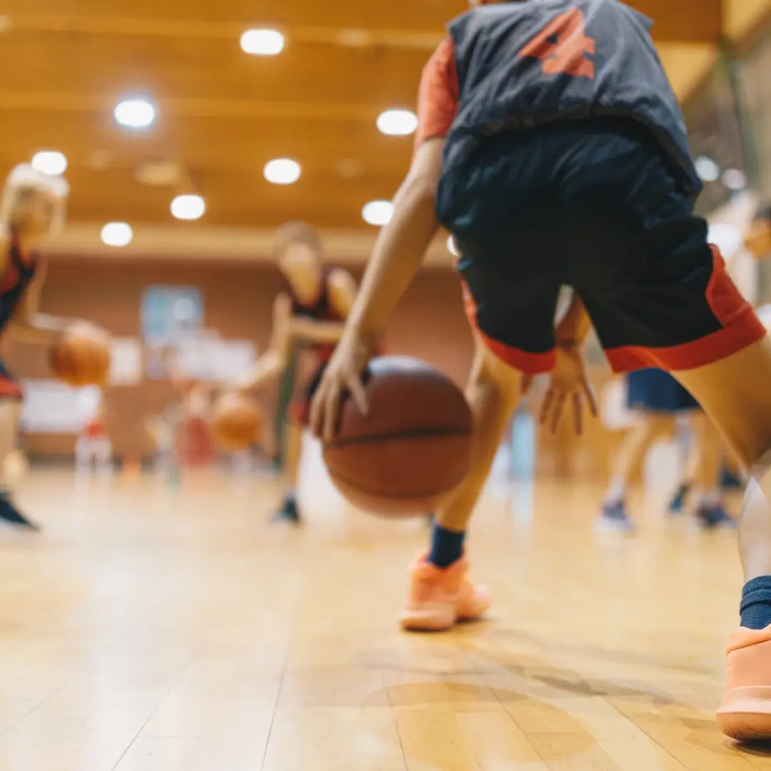 People in sports hall playing basketball