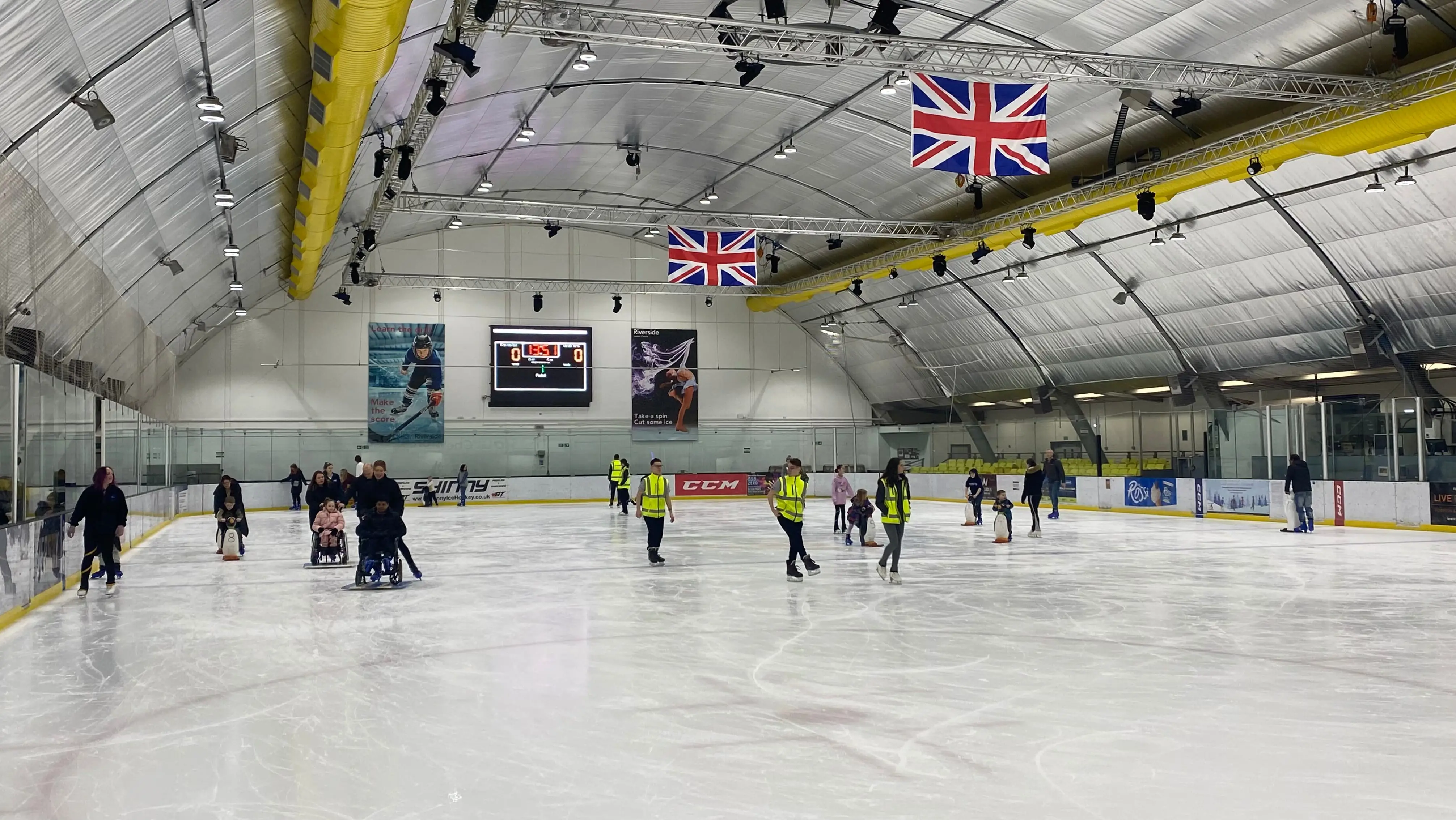 A group of people learning to ice skate