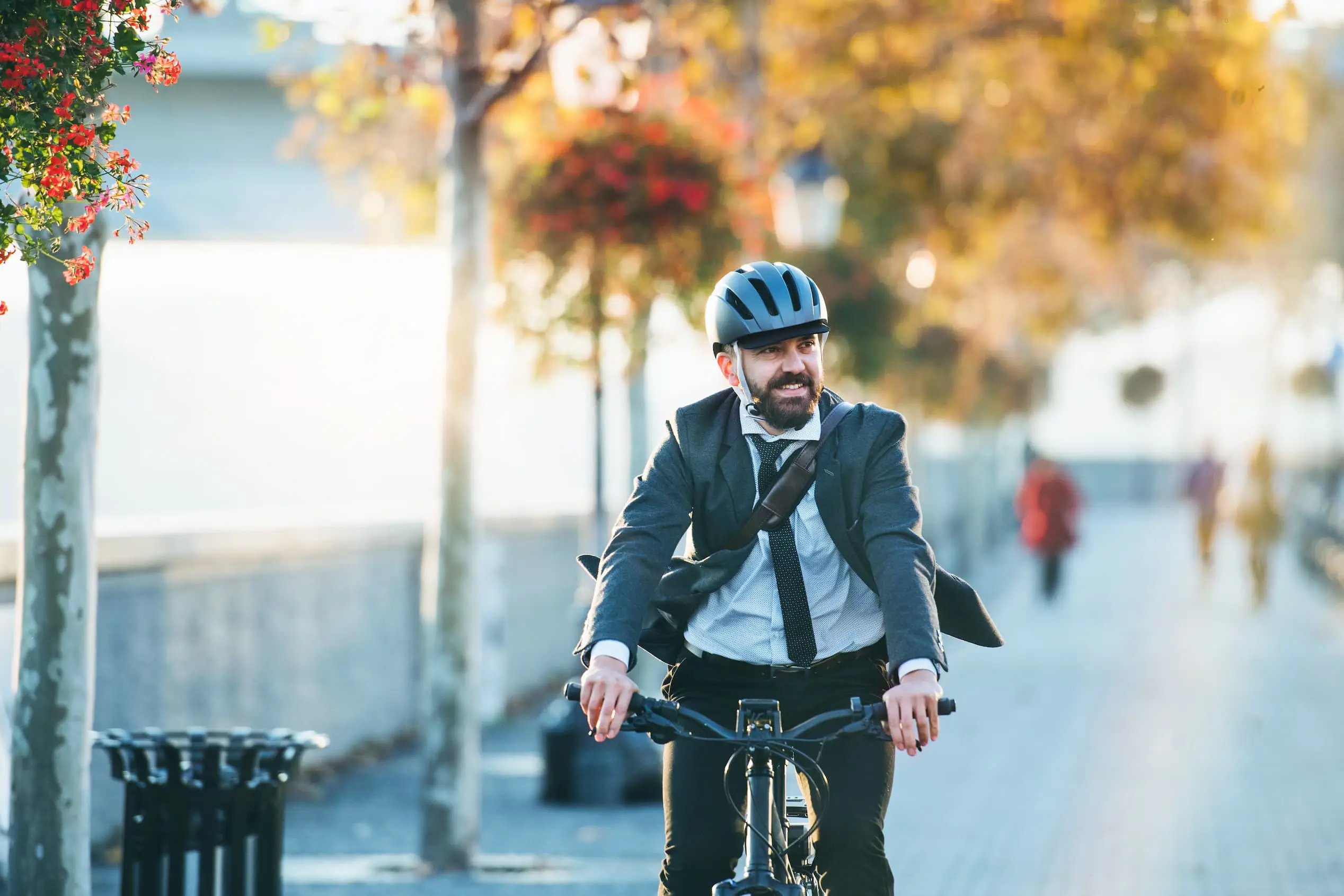 Man in suit riding bike in urban area