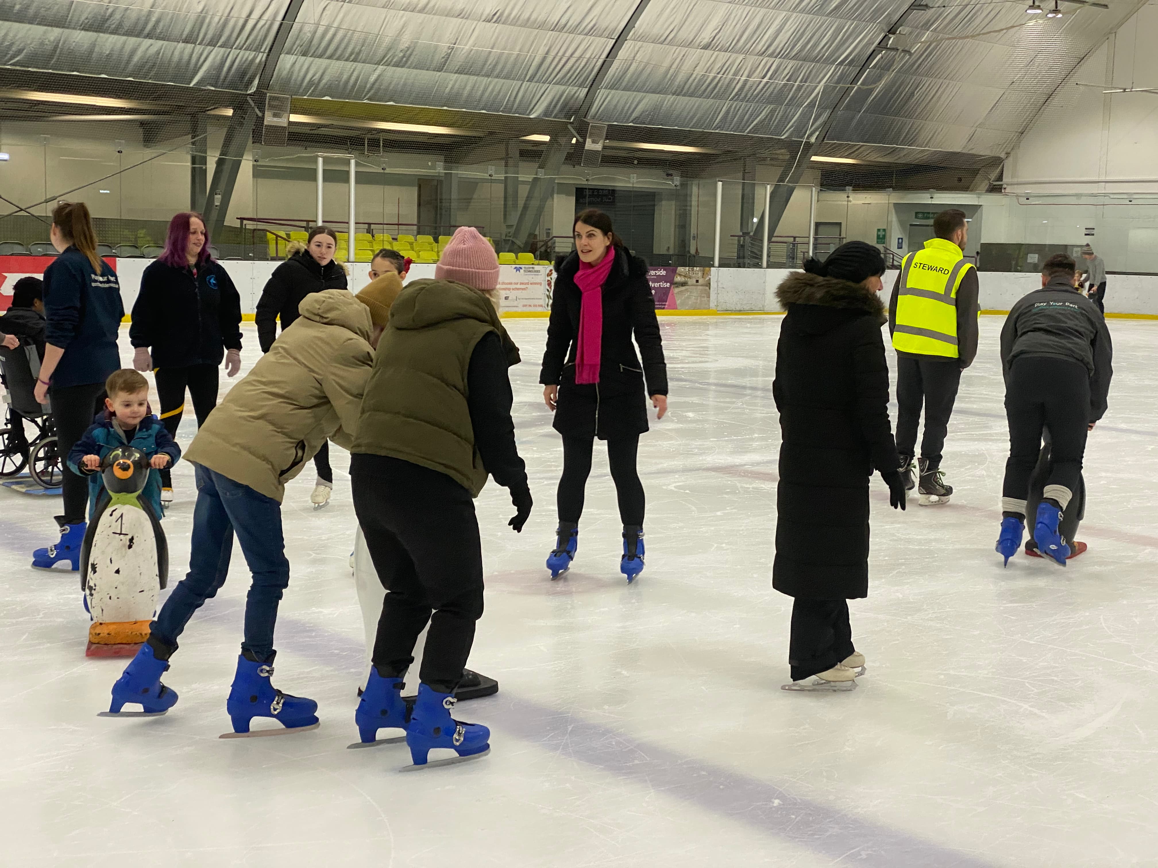 Parents and children ice skating together preview