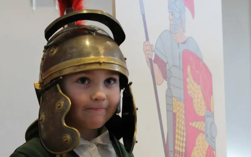 Young girl in a Roman helmet