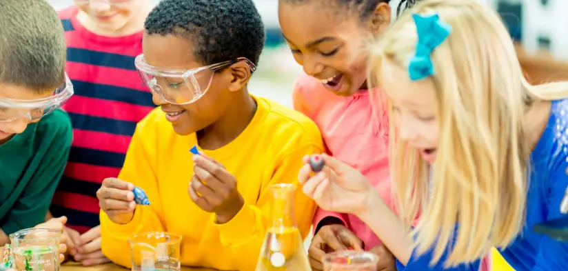 Children in protective eyewear experimenting with science kit