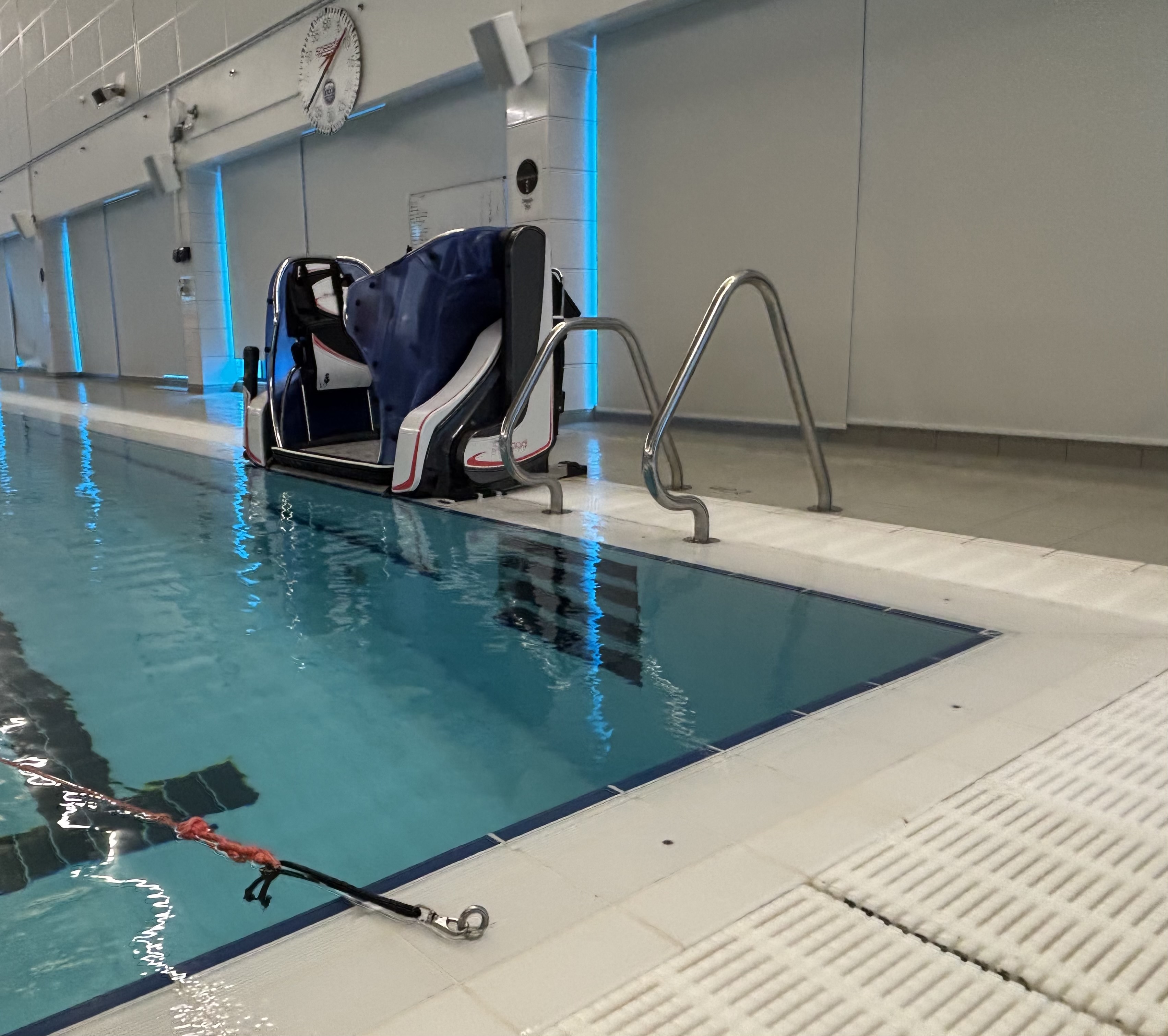 Large accessibility equipment to help people in wheelchairs access swimming pool