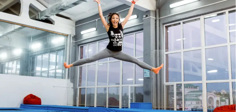 Woman in mid-air while jumping on a trampoline