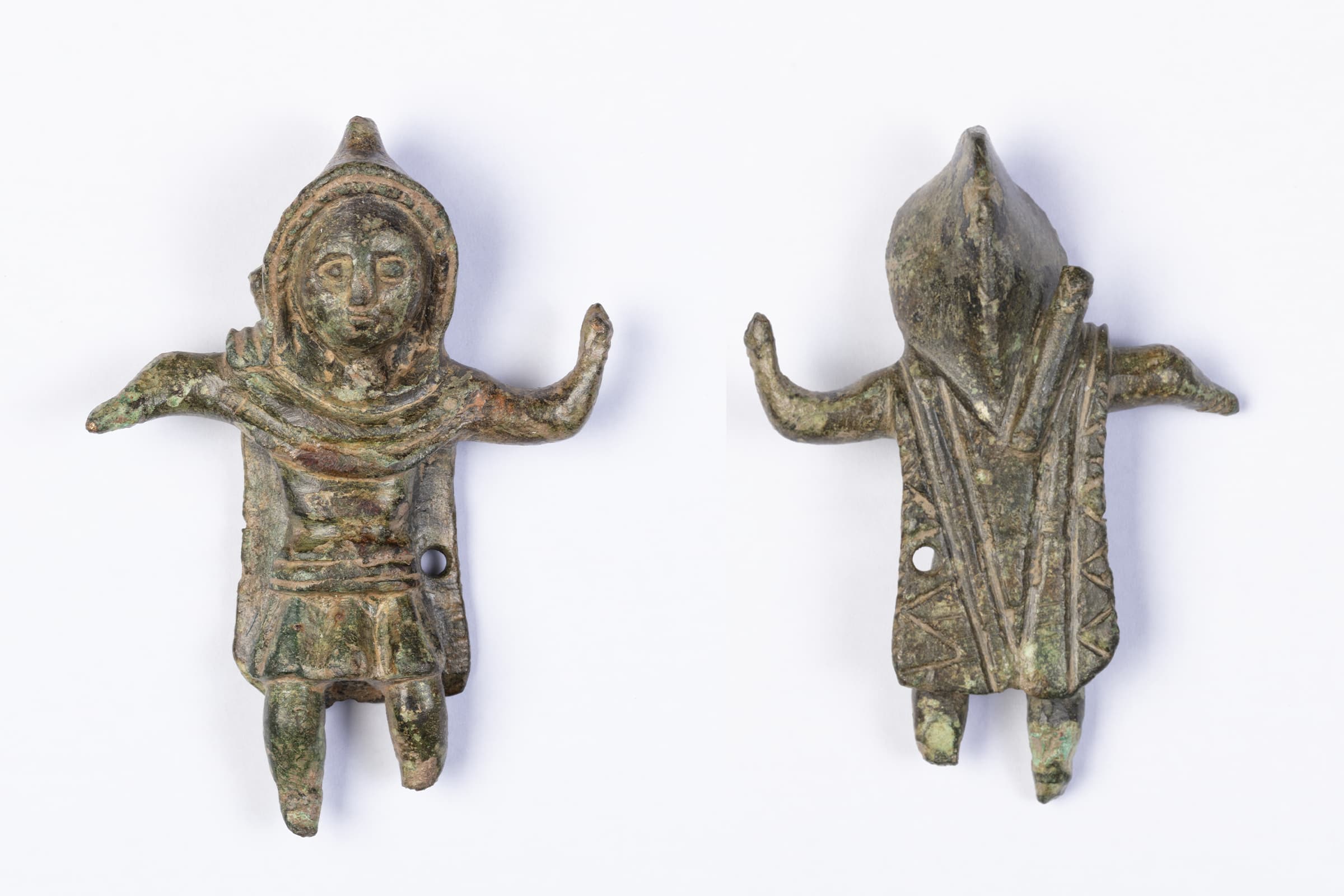 Front and back of a tiny statue wearing a hooded cloak. 