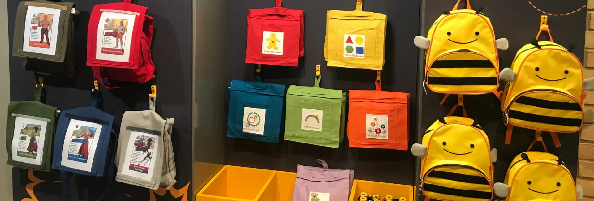 Colourful children's backpacks on wall display