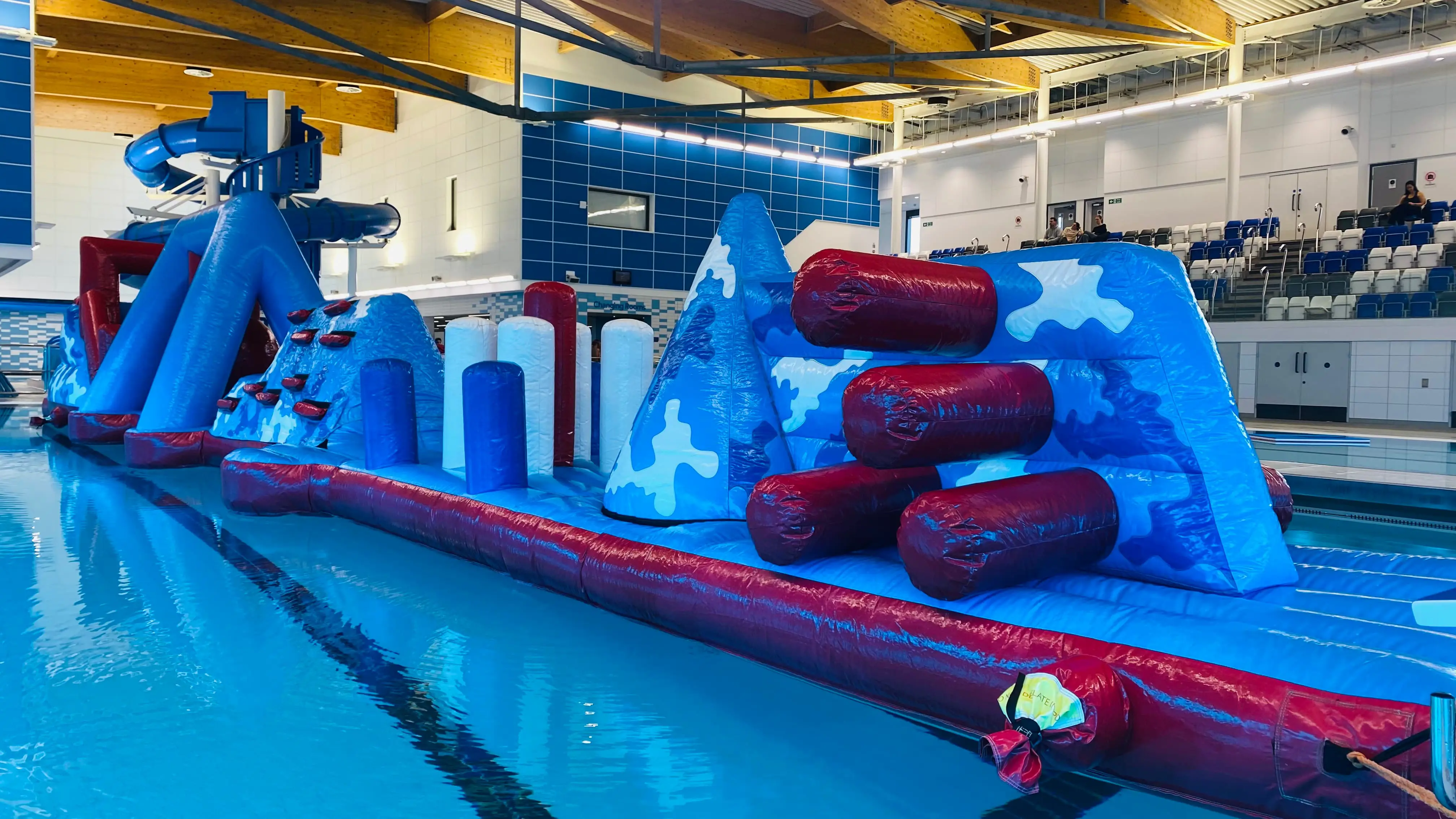 Large blue and red inflatable assault course floating on top of water at Riverside swimming pool