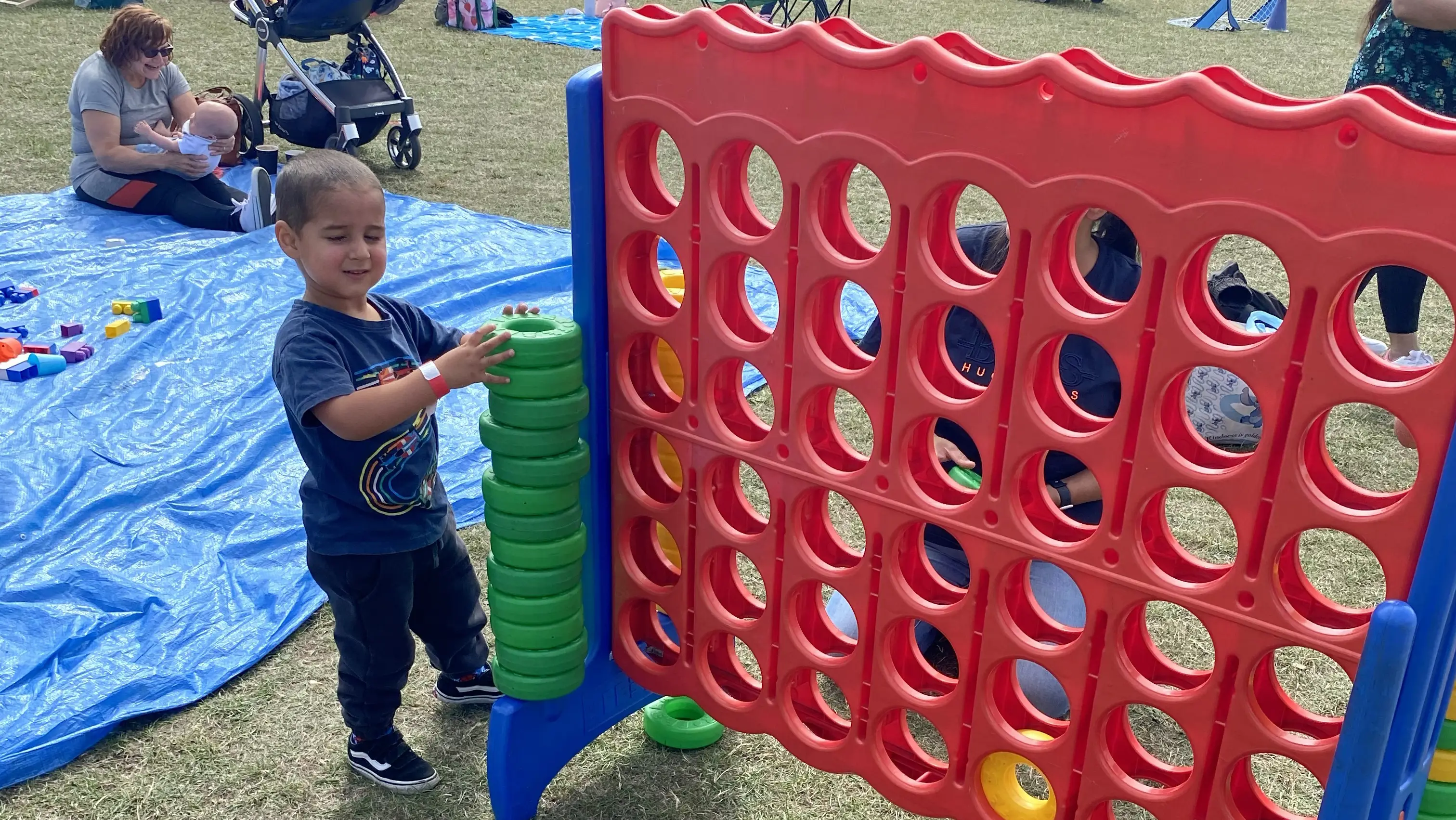 Boy playing with giant Connect 4 game