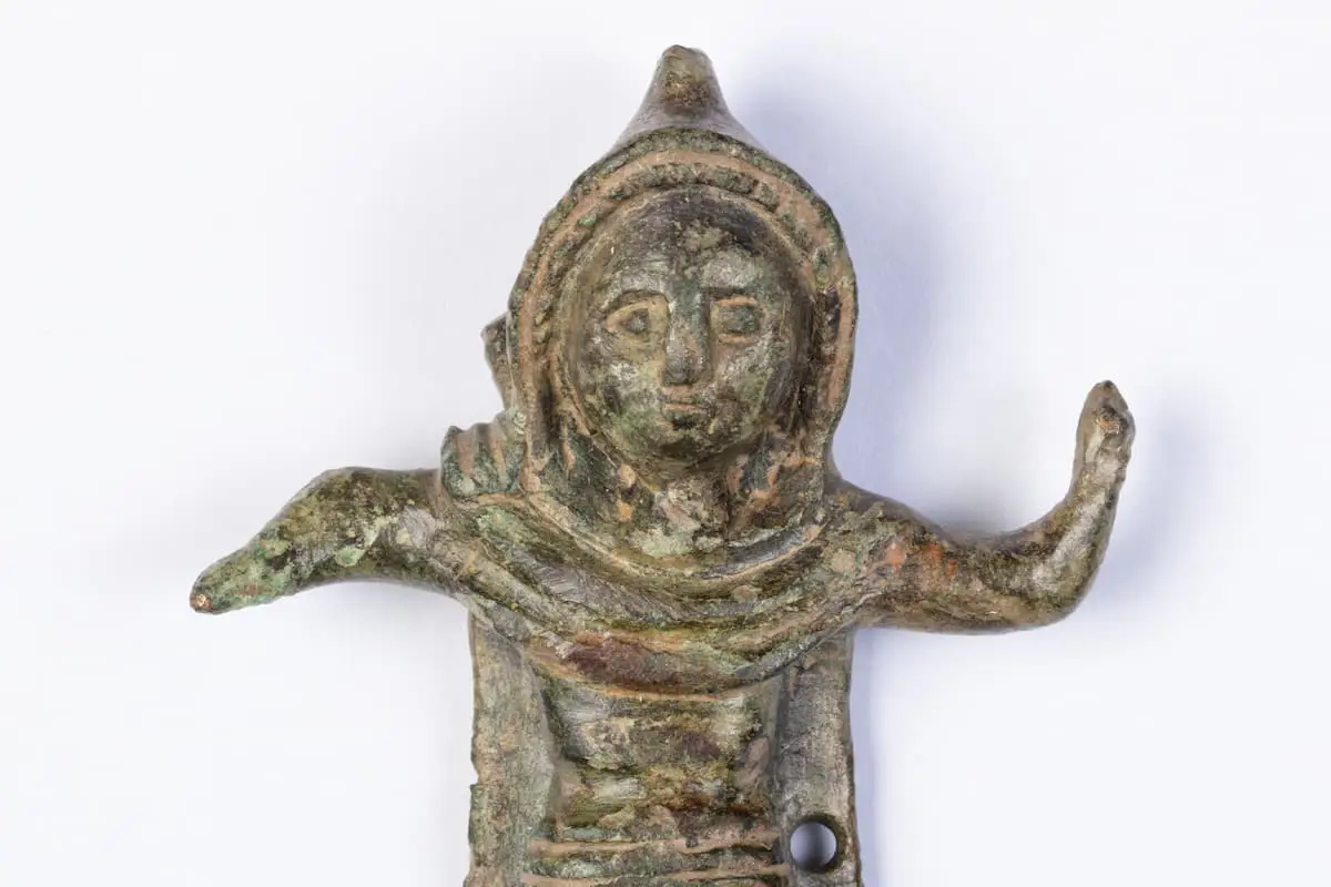 A tiny statue wearing a hooded cloak