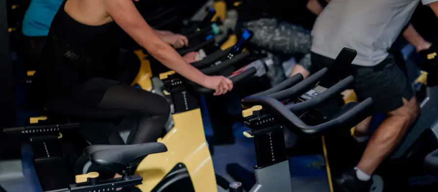 People on stationary bikes in spin studio