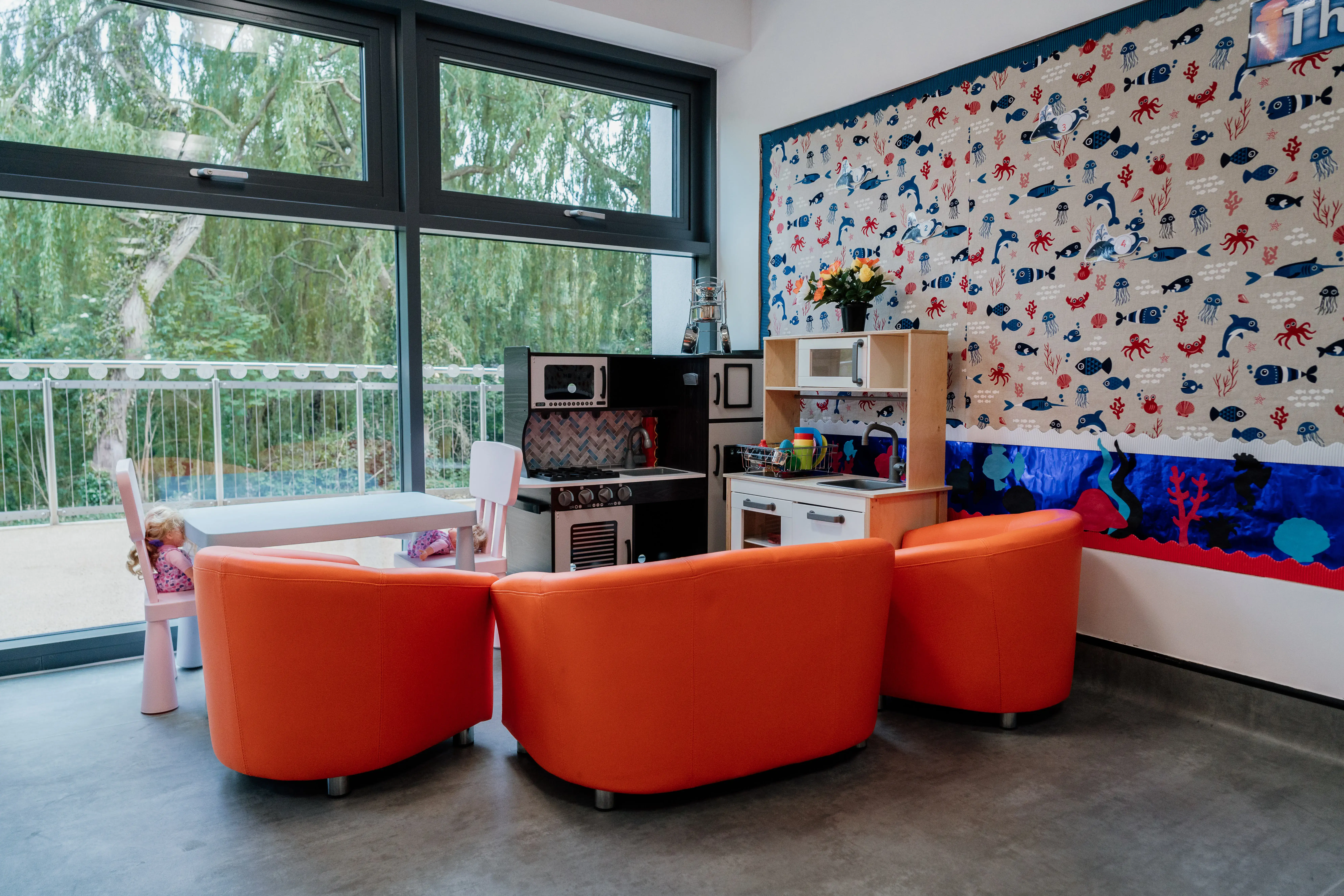 Kitchen play area with orange seating