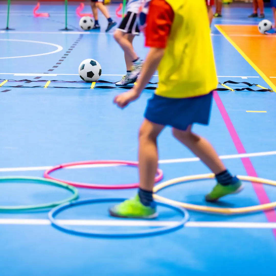 Children in sports hall taking part in fun races