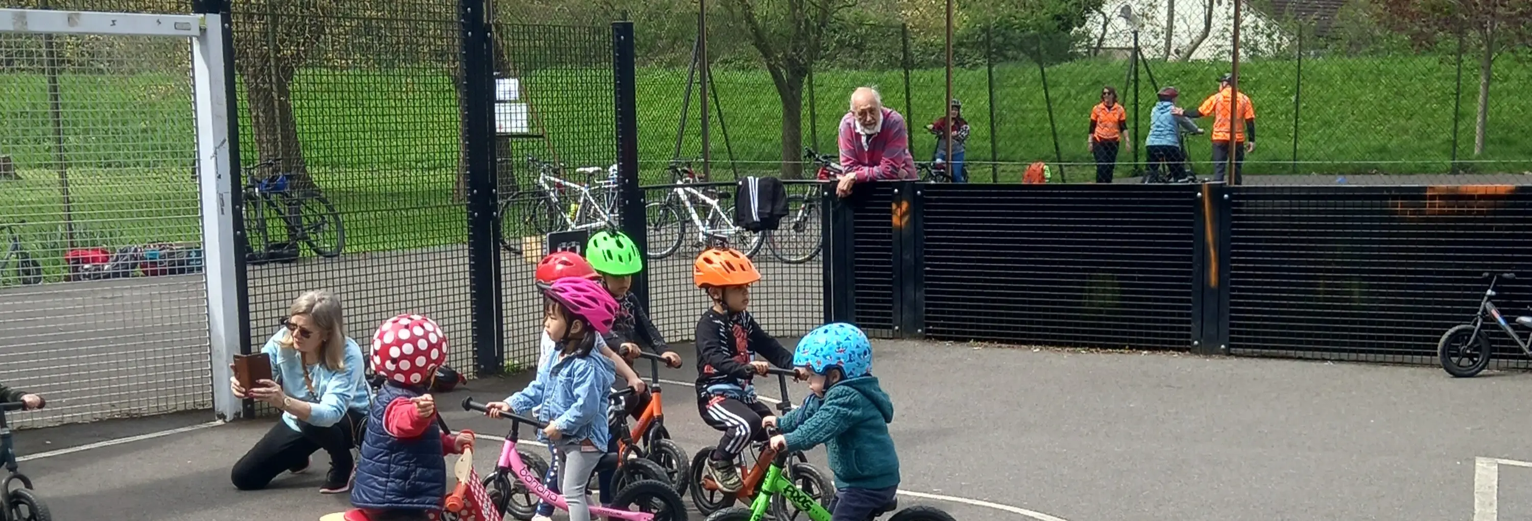 Group of small children learning to ride bikes