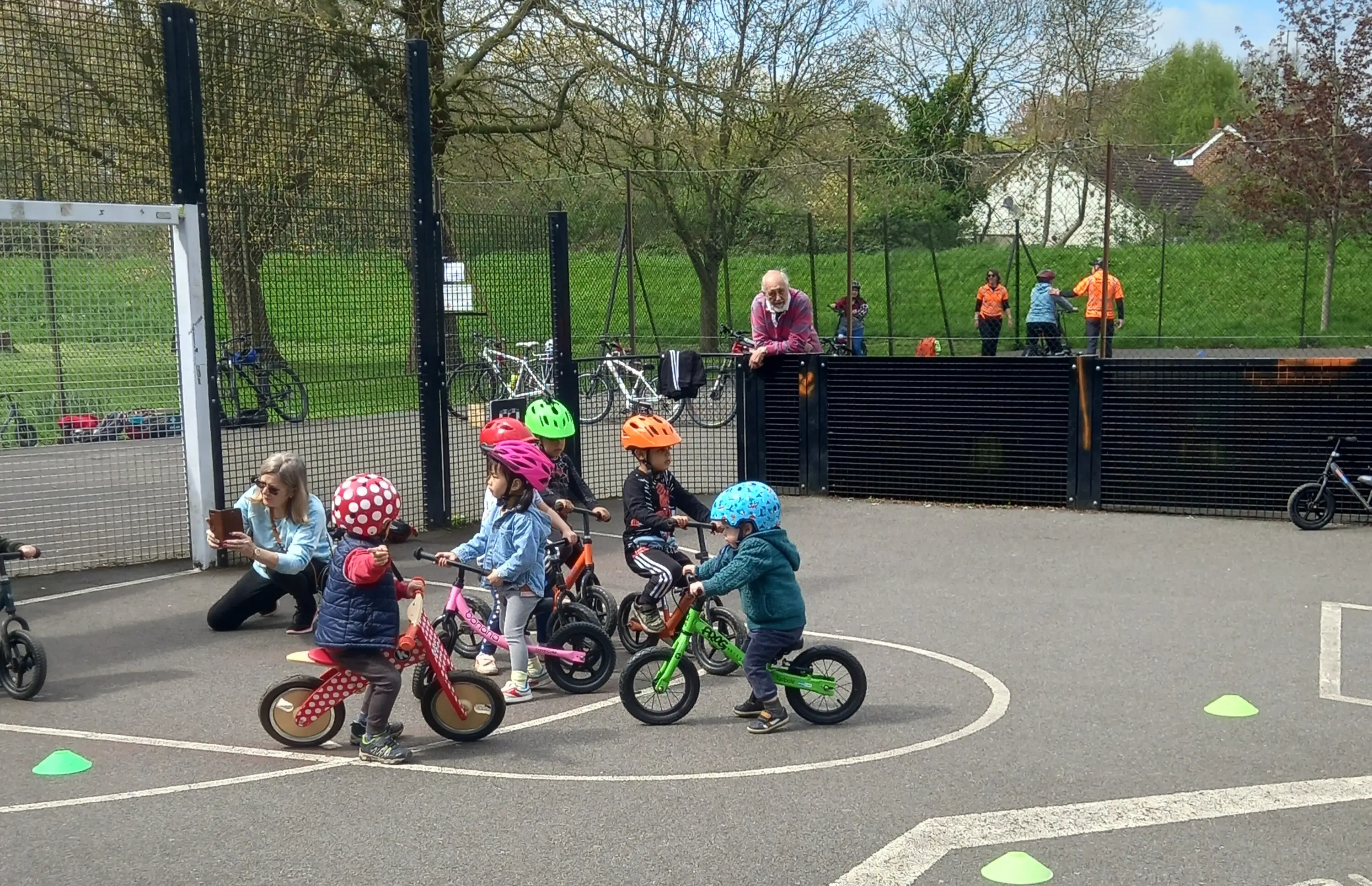Group of small children learning to ride bikes