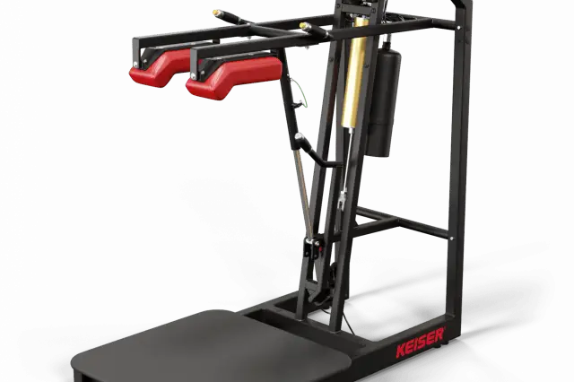 A standing platform with padded shoulder rests providing resistance to your squats, and a screen to track progress.
