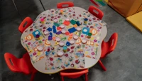 Small round table laid out for craft activity preview